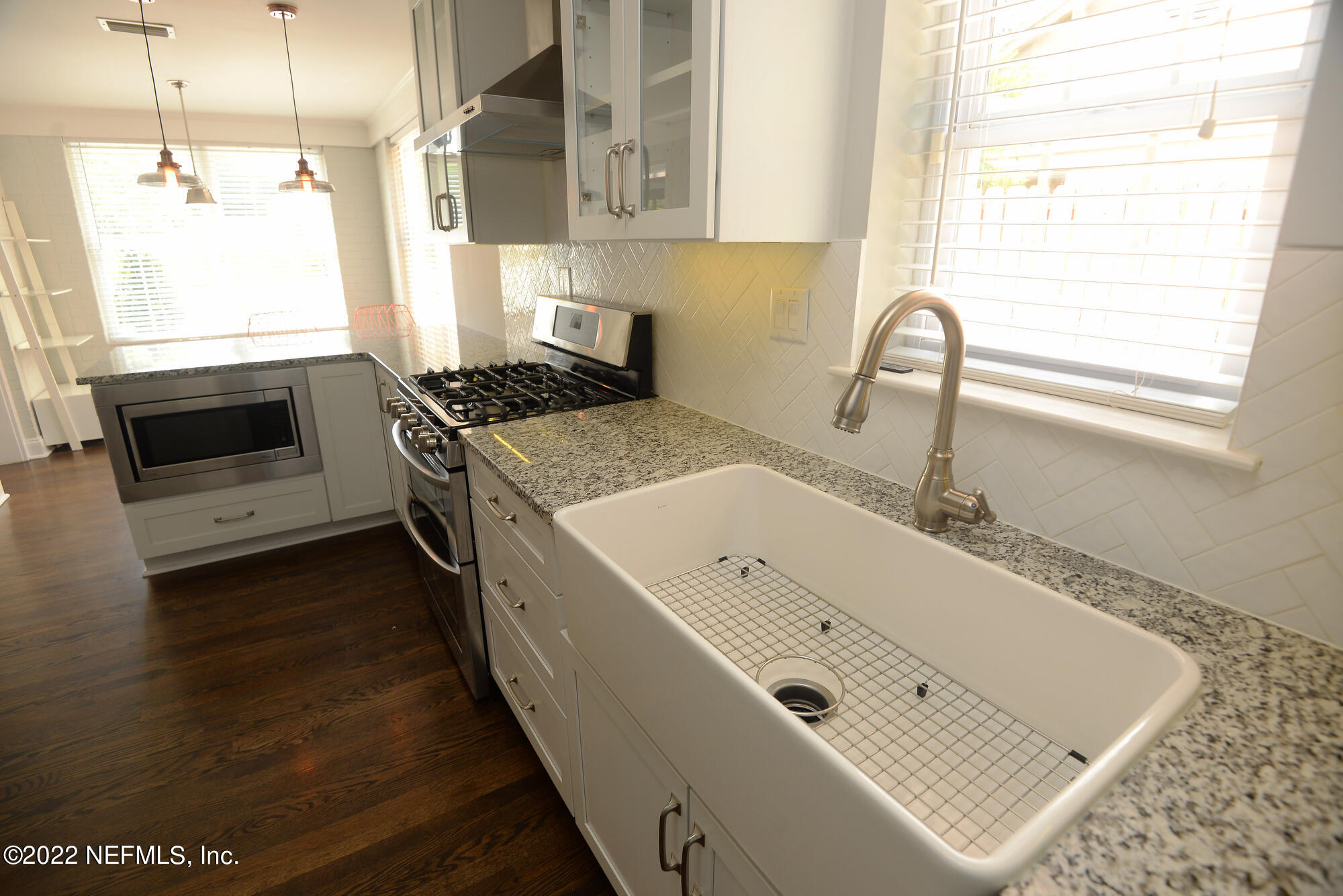 3973 Gadsden Road Jacksonville, FL 32207 - Photo 12 of 45 a kitchen with a sink a stove and cabinets