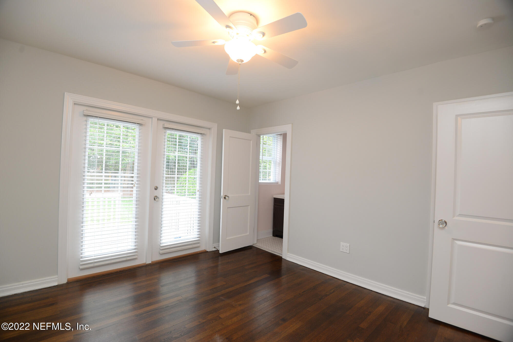 3973 Gadsden Road Jacksonville, FL 32207 - Photo 17 of 45 an empty room with wooden floor and windows