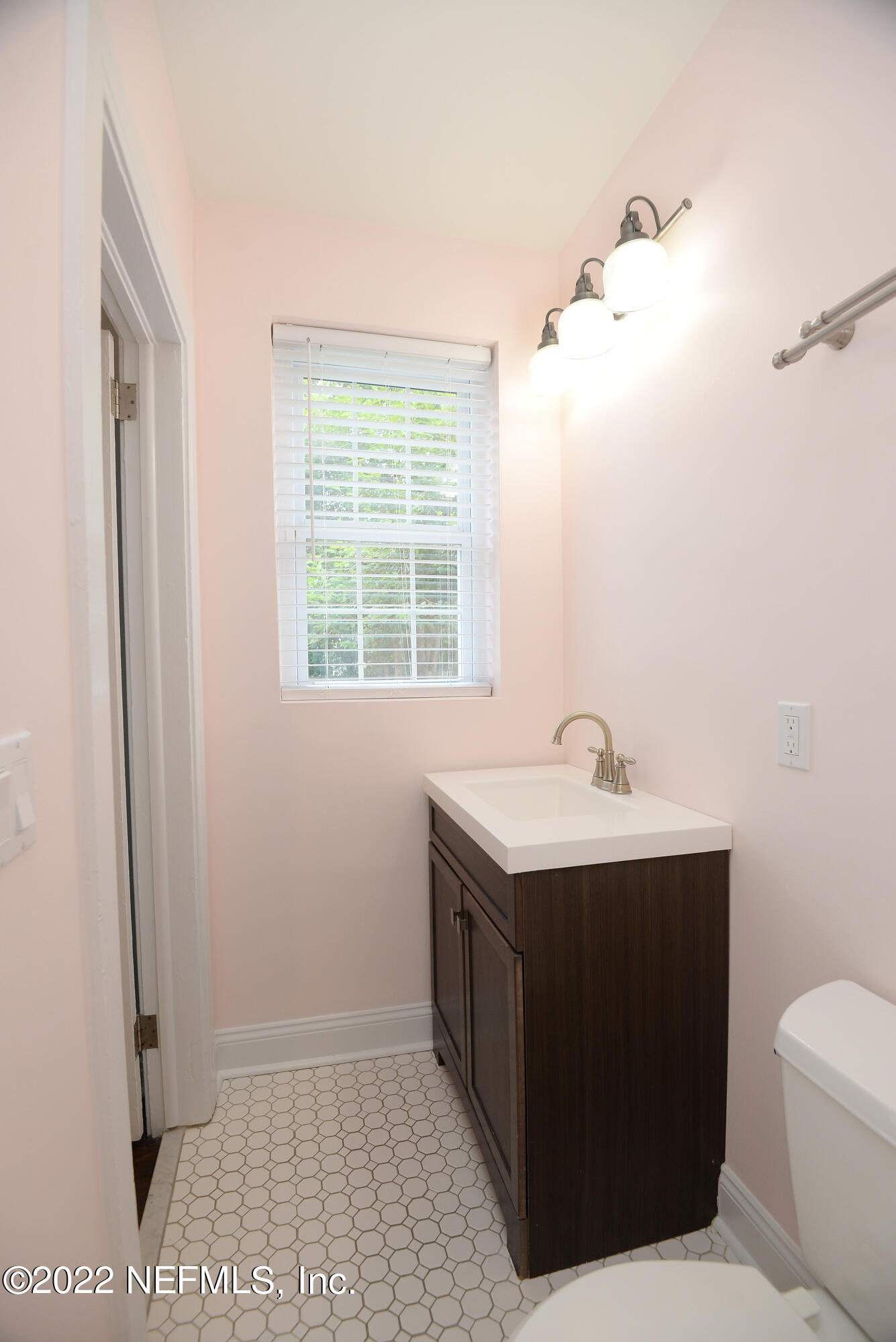 3973 Gadsden Road Jacksonville, FL 32207 - Photo 19 of 45 a bathroom with a sink toilet and vanity
