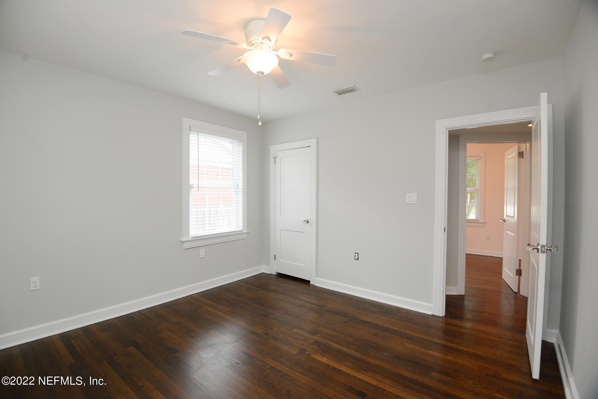 3973 Gadsden Road Jacksonville, FL 32207 - Photo 22 of 45 an empty room with wooden floor and windows