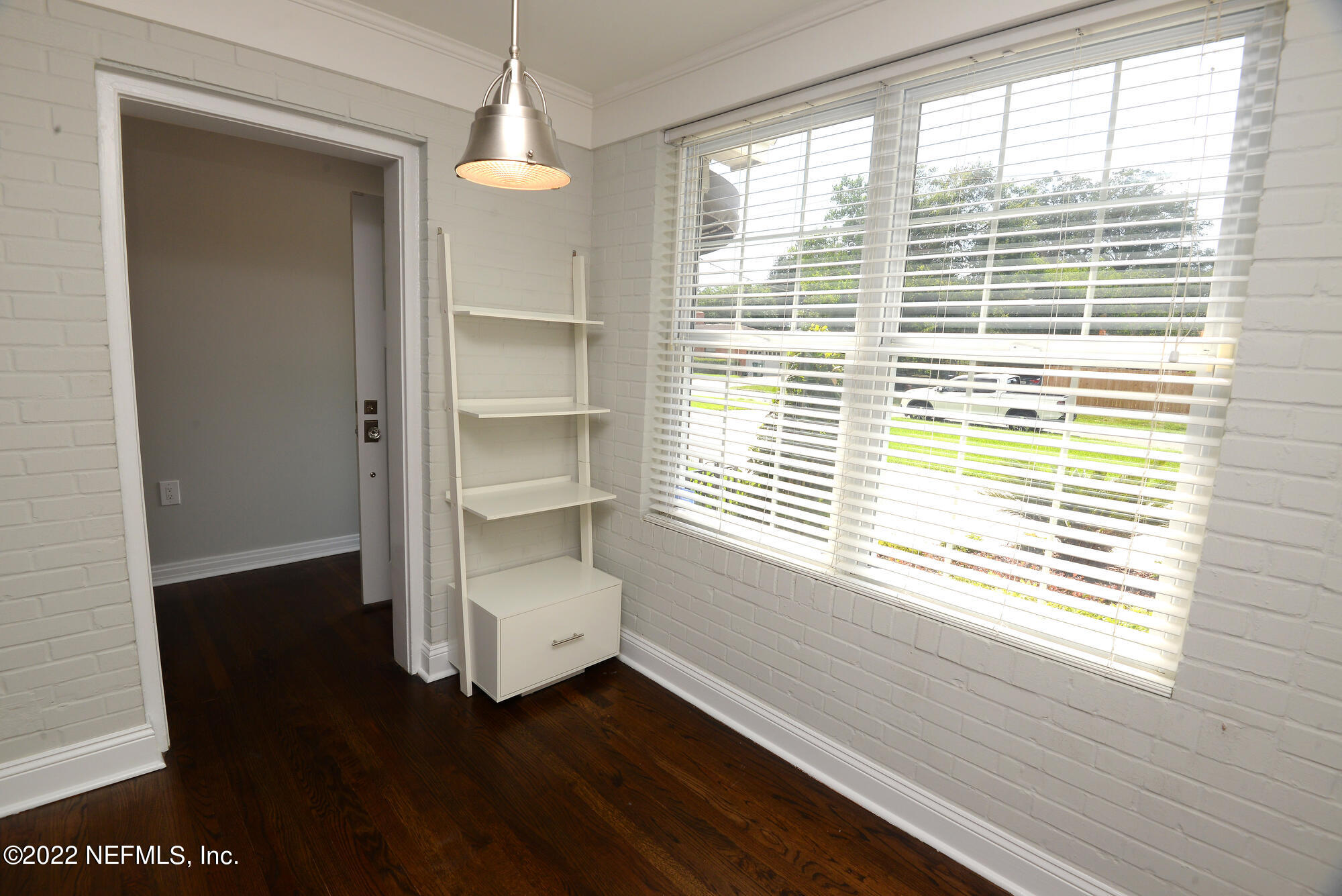 3973 Gadsden Road Jacksonville, FL 32207 - Photo 6 of 45 a room with a window and wooden floor