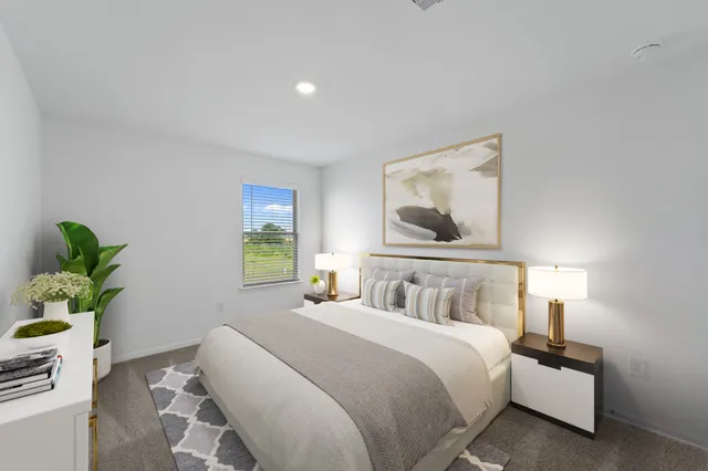 a bedroom with bed and a painting on the wall