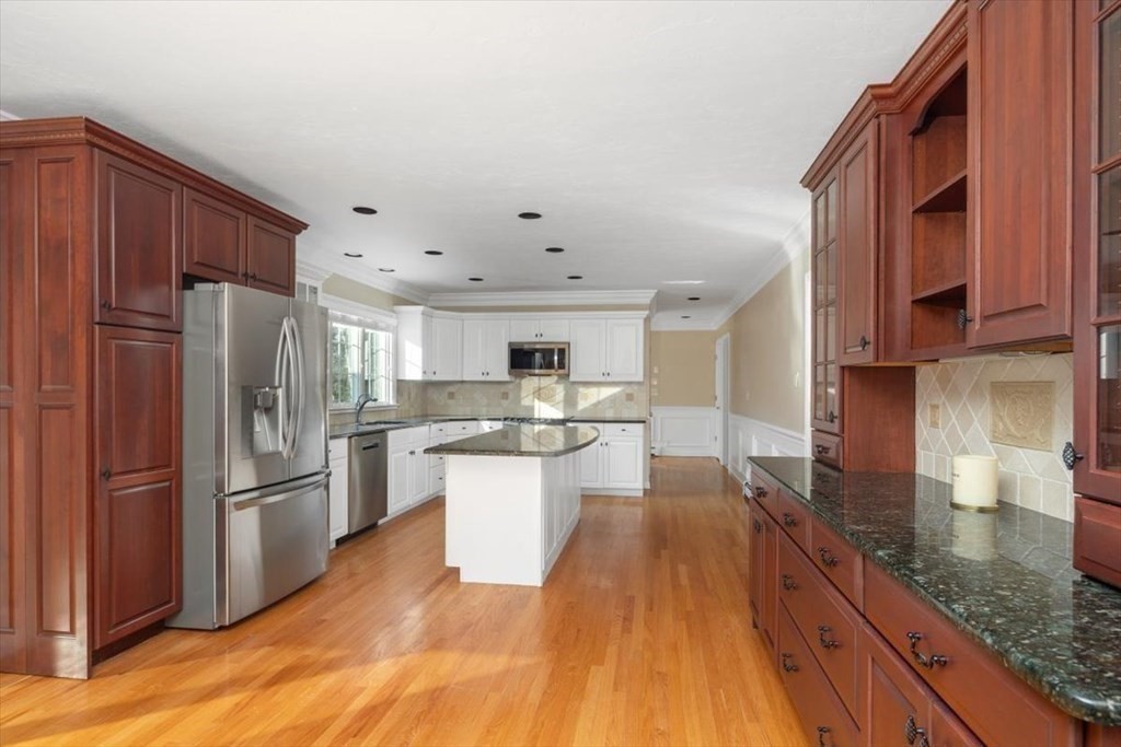 1 Huckleberry Hill Lane Hingham, MA 02043 - Photo 12 of 30 a kitchen with granite countertop a refrigerator stove top oven and sink