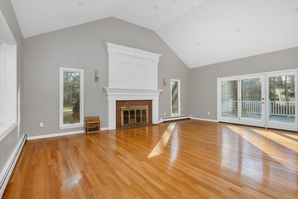 1 Huckleberry Hill Lane Hingham, MA 02043 - Photo 7 of 30 a view of empty room with wooden floor and fireplace