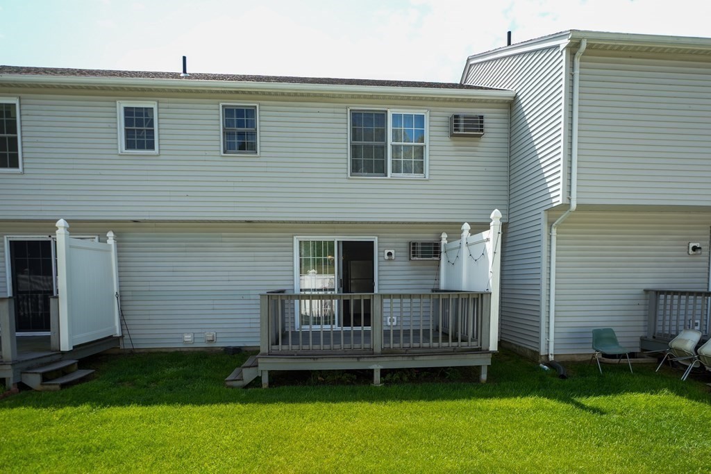 283 Fuller Road, Unit E Chicopee, MA 01020 - Photo 21 of 21 a view of a house with a backyard