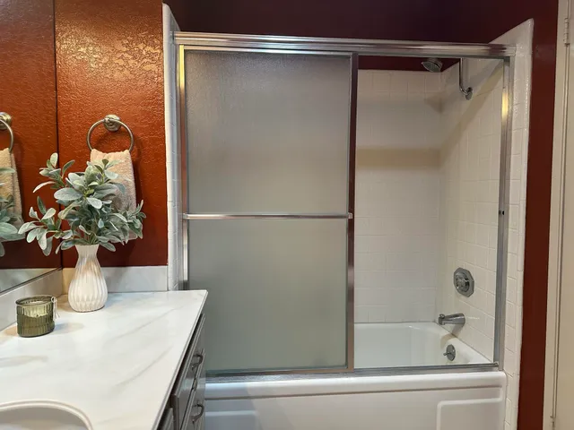 a vase of flowers sitting on a floor