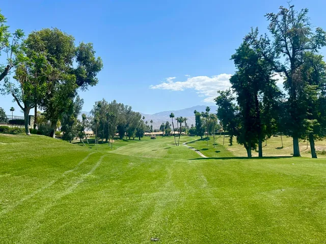 a view of a dining room with furniture and a chandelier