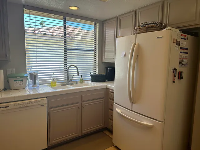 a kitchen with cabinets appliances and a sink