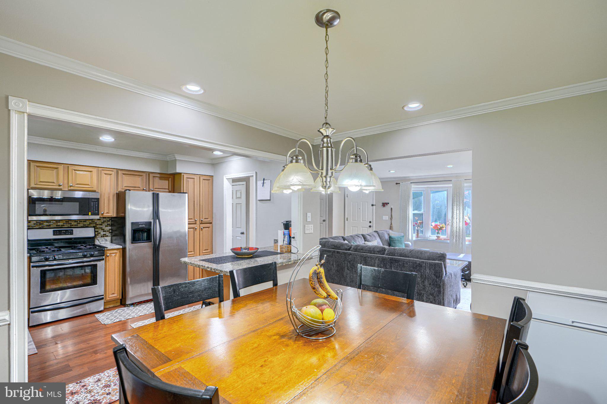 3708 Cassen Road Randallstown, MD 21133 - Photo 9 of 38 a room with stainless steel appliances kitchen island granite countertop a table and chairs in it