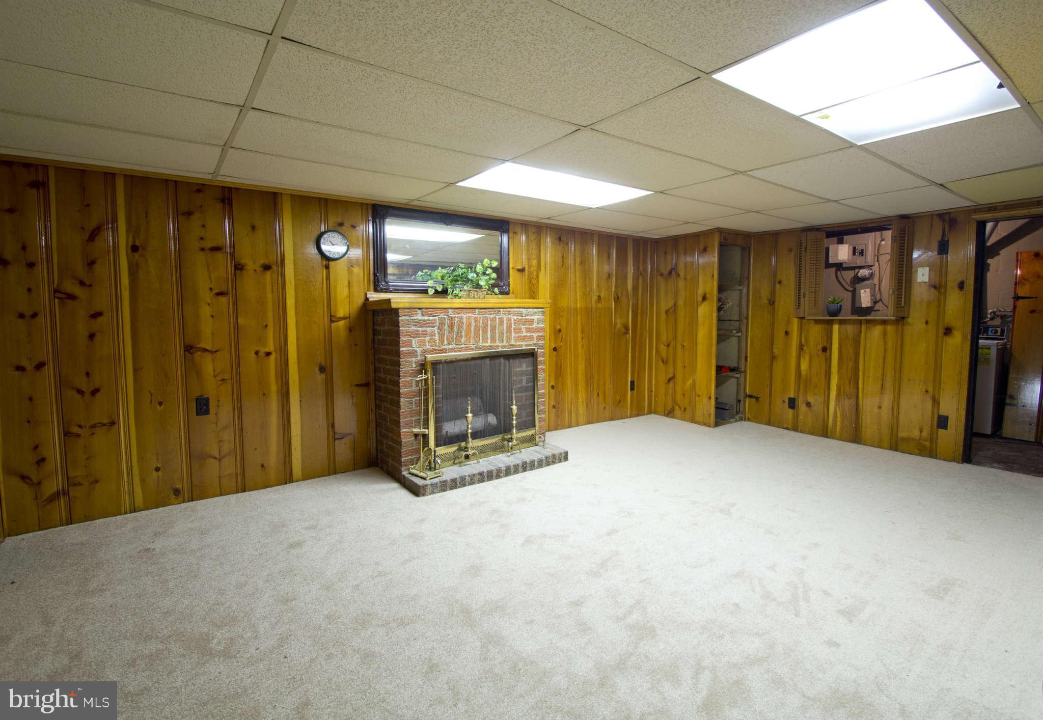 329 Grove Park Road Baltimore, MD 21225 - Photo 7 of 19 a view of an empty room with a fireplace