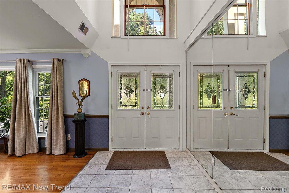 1450 Lenox Road Bloomfield Hills, MI 48304 - Photo 10 of 79 Grand entryway featuring dual sets of double doors with decorative glass panels, a high vaulted ceiling, and transom windows