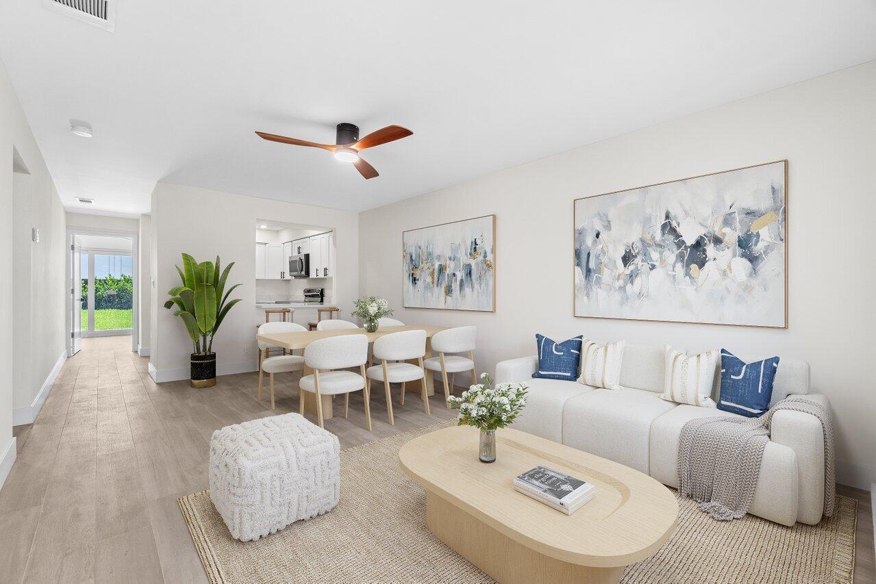 a living room with furniture potted plant and a chandelier