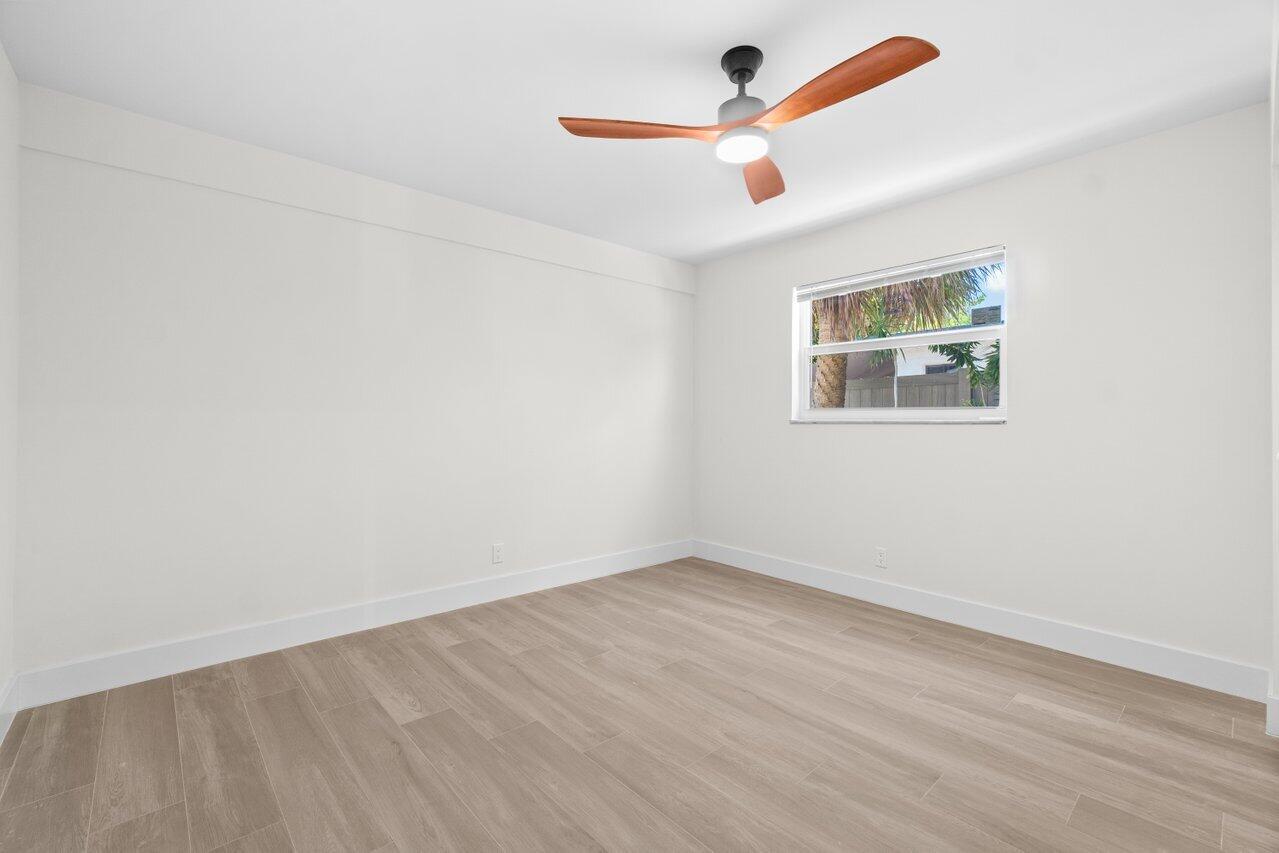4498 Northwest 2nd Avenue Boca Raton, FL 33431 - Photo 13 of 43 an empty room with a window and a ceiling fan