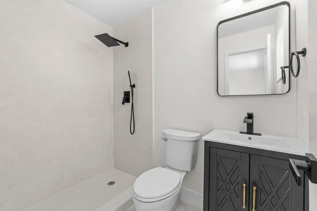 a white toilet sitting next to a bathroom sink