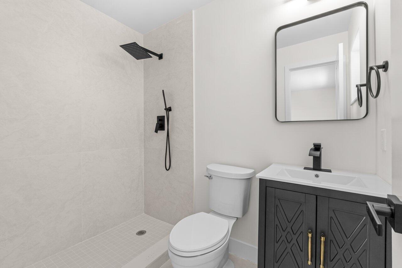 4498 Northwest 2nd Avenue Boca Raton, FL 33431 - Photo 17 of 43 a white toilet sitting next to a bathroom sink