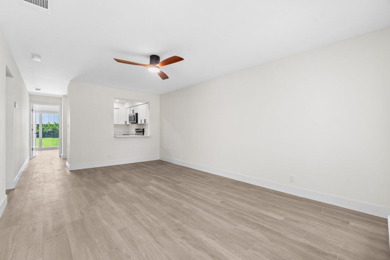 4498 Northwest 2nd Avenue Boca Raton, FL 33431 - Photo 2 of 43 wooden floor in an empty room with a window
