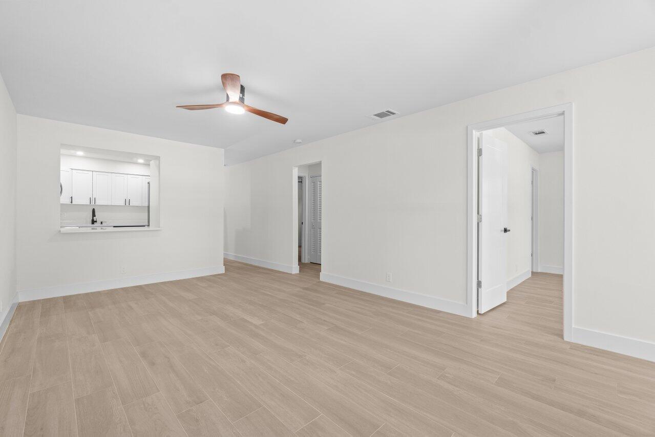 4498 Northwest 2nd Avenue Boca Raton, FL 33431 - Photo 22 of 43 an empty room with wooden floor ceiling fan and windows