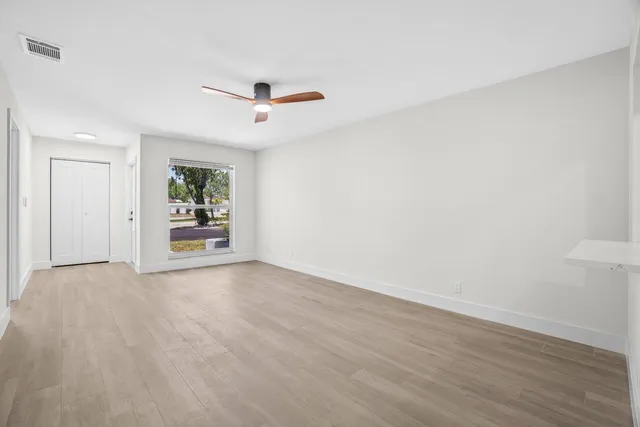 a view of an empty room with a window