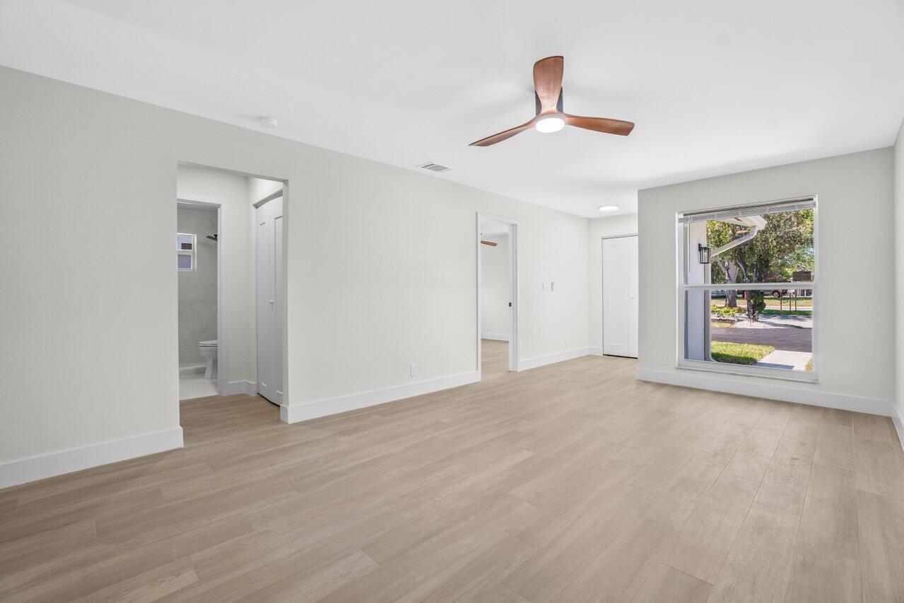 4498 Northwest 2nd Avenue Boca Raton, FL 33431 - Photo 25 of 43 a view of an empty room with wooden floor and a window