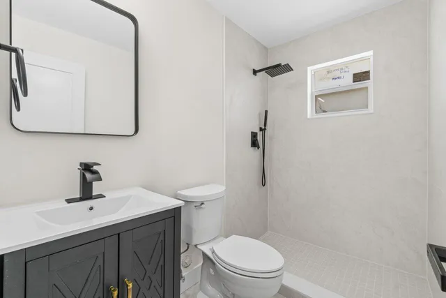 a bathroom with a toilet sink and mirror