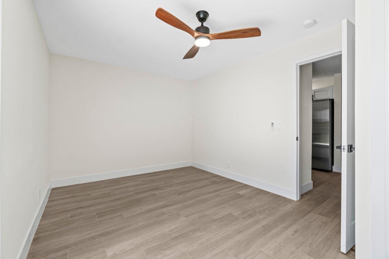 4498 Northwest 2nd Avenue Boca Raton, FL 33431 - Photo 36 of 43 an empty room with wooden floor ceiling fan and window
