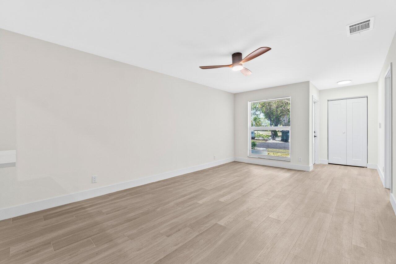 4498 Northwest 2nd Avenue Boca Raton, FL 33431 - Photo 8 of 43 an empty room with wooden floor and ceiling fan