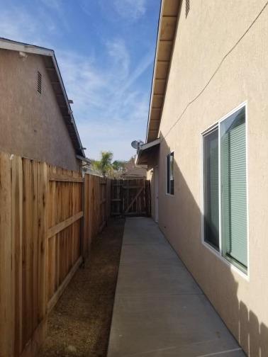 6565 Nicholas Drive Winton, CA 95388 - Photo 16 of 17 a view of a pathway of a house with wooden fence