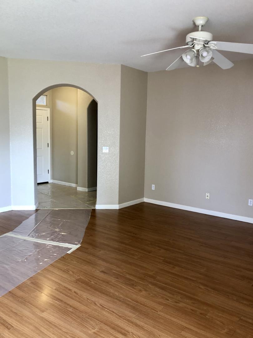 6565 Nicholas Drive Winton, CA 95388 - Photo 5 of 17 a view of an empty room with wooden floor and a chandelier