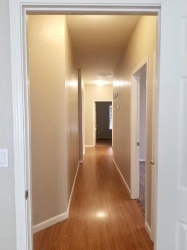 6565 Nicholas Drive Winton, CA 95388 - Photo 7 of 17 a view of a hallway with wooden floor