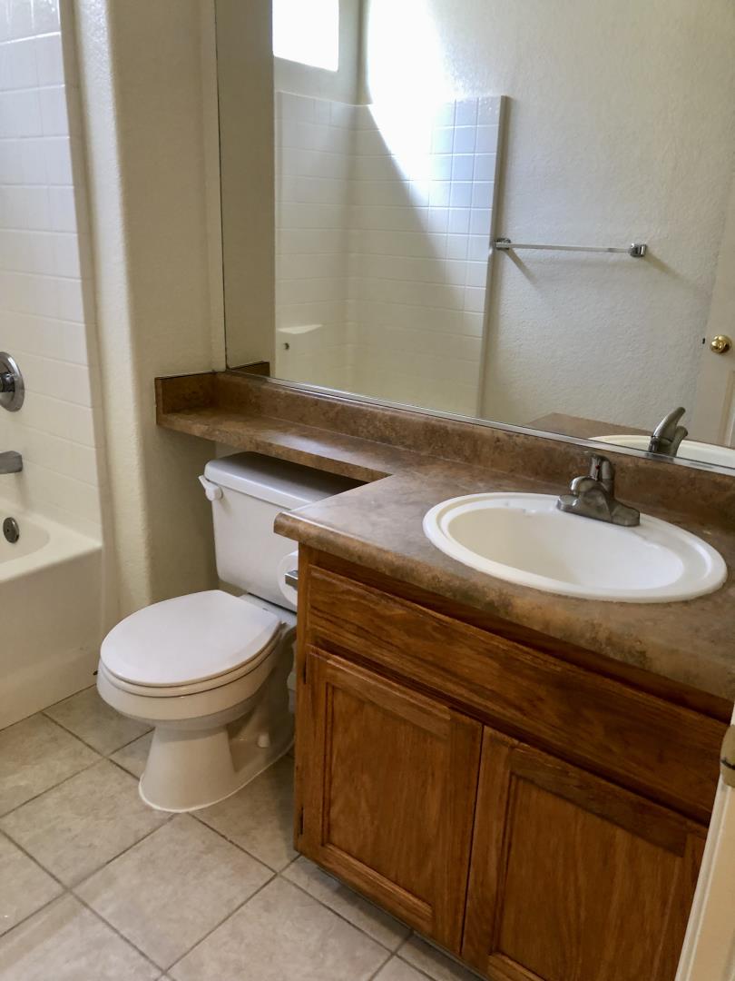 6565 Nicholas Drive Winton, CA 95388 - Photo 10 of 17 a bathroom with a granite countertop toilet sink and mirror