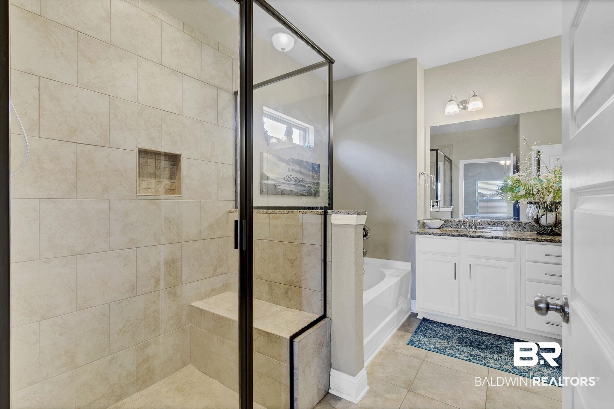 1547 Kairos Loop Foley, AL 36535 - Photo 20 of 55 Full bathroom with a stall shower, tile patterned flooring, a garden tub, and vanity