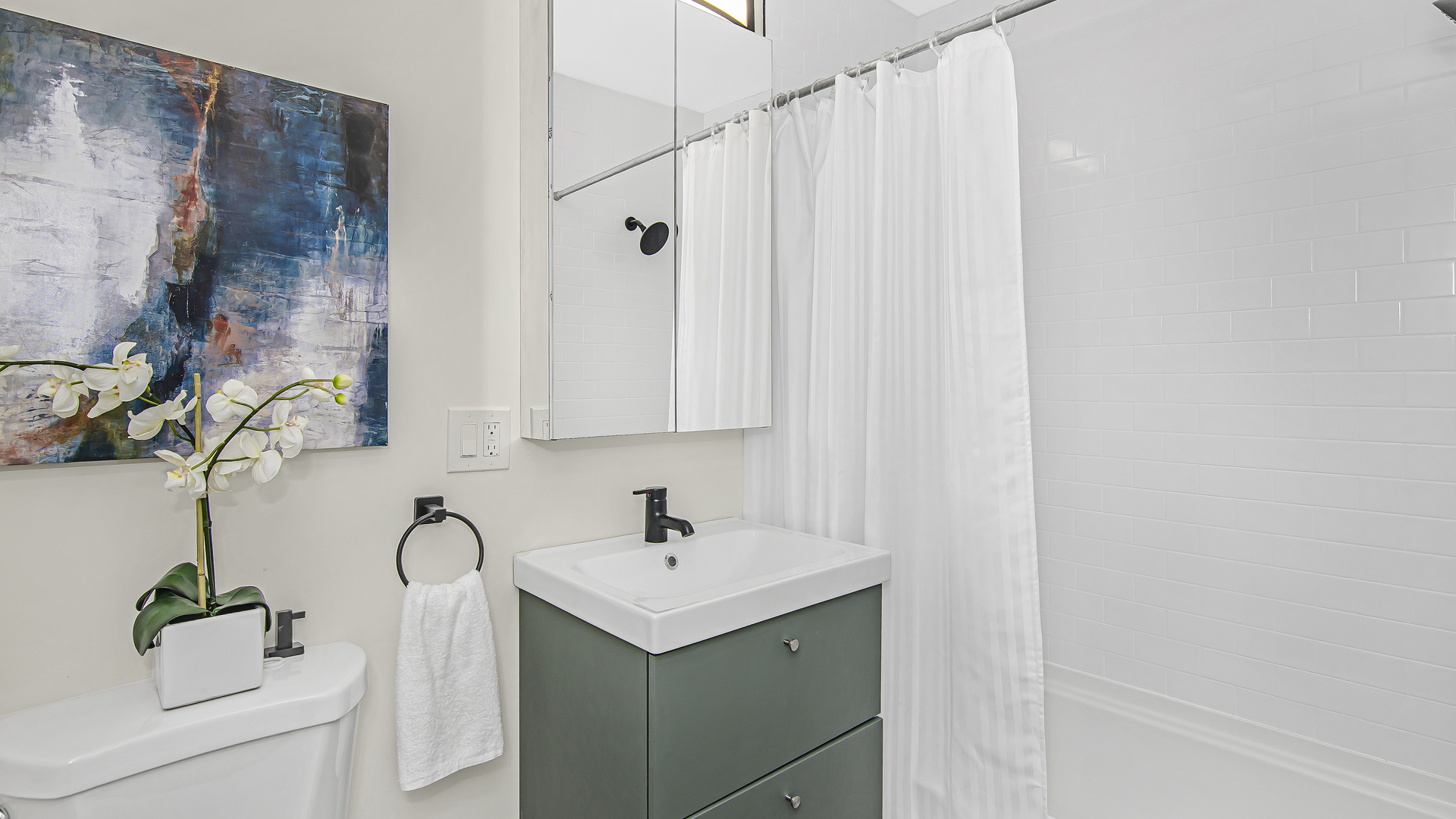 2315 West Rice Street, Unit 1N Chicago, IL 60622 - Photo 19 of 37 a bathroom with a sink and a mirror