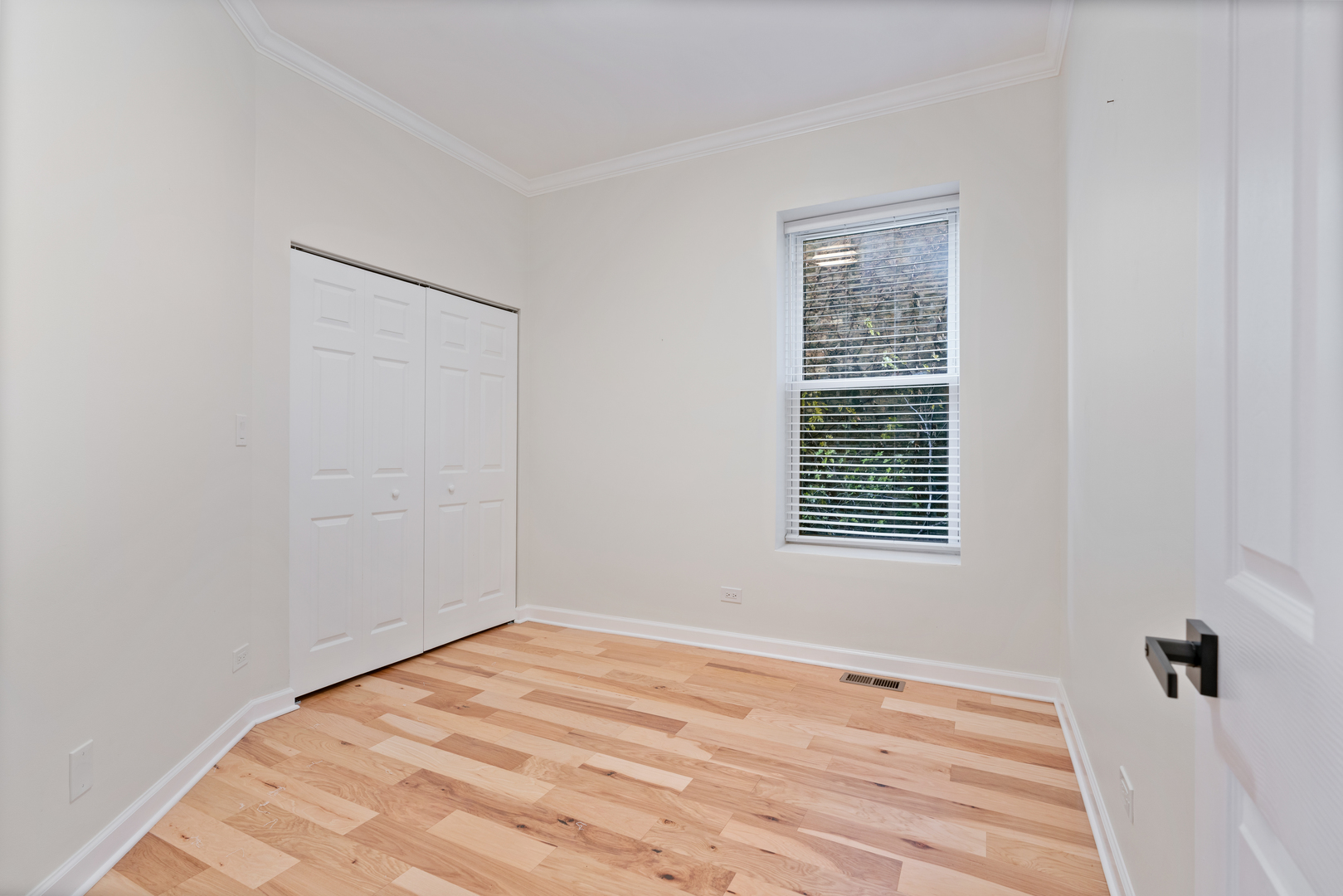 2315 West Rice Street, Unit 1N Chicago, IL 60622 - Photo 22 of 37 a view of an empty room with wooden floor and a window