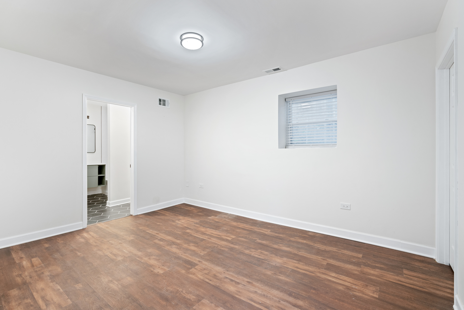 2315 West Rice Street, Unit 1N Chicago, IL 60622 - Photo 29 of 37 an empty room with wooden floor and windows