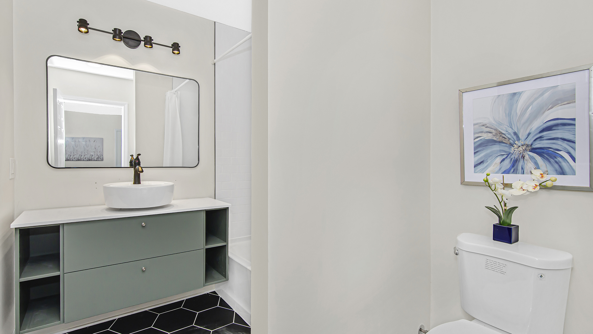 2315 West Rice Street, Unit 1N Chicago, IL 60622 - Photo 32 of 37 a bathroom with a sink a mirror and a toilet