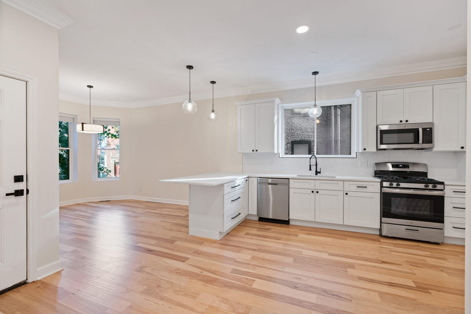 2315 West Rice Street, Unit 1N Chicago, IL 60622 - Photo 4 of 37 a large kitchen with a wooden floor and stainless steel appliances