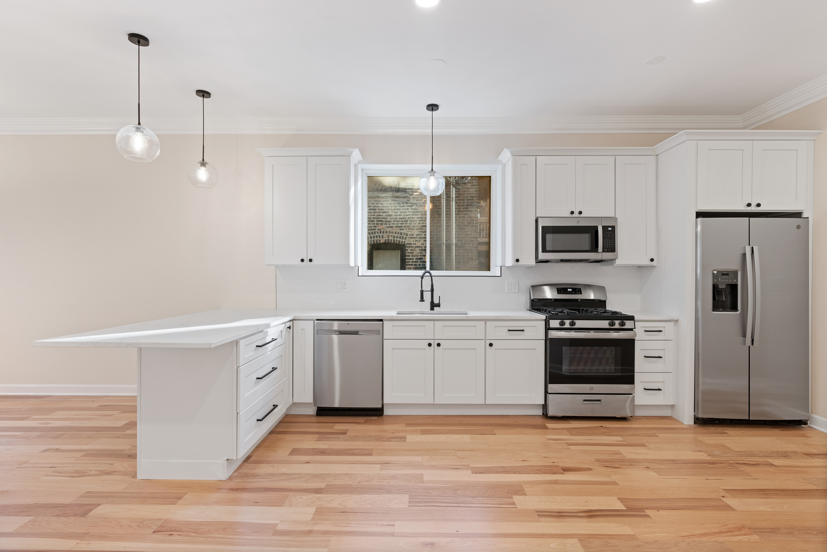 2315 West Rice Street, Unit 1N Chicago, IL 60622 - Photo 5 of 37 a kitchen with stainless steel appliances granite countertop a stove a sink and a refrigerator