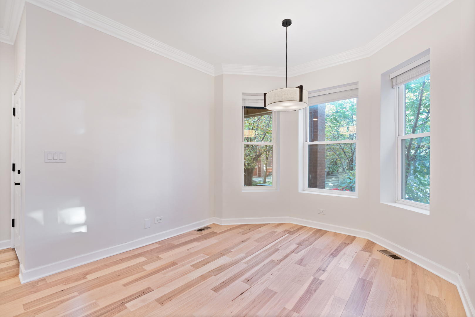 2315 West Rice Street, Unit 1N Chicago, IL 60622 - Photo 8 of 37 a view of a room with wooden floor windows and ceiling fan