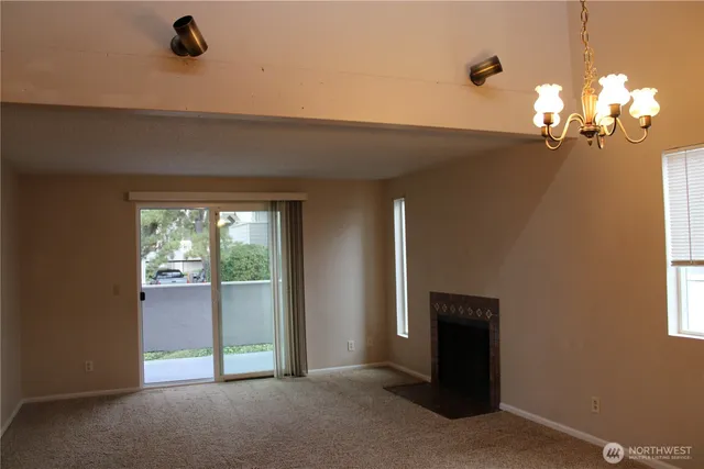 a view of a livingroom with a ceiling fan and window