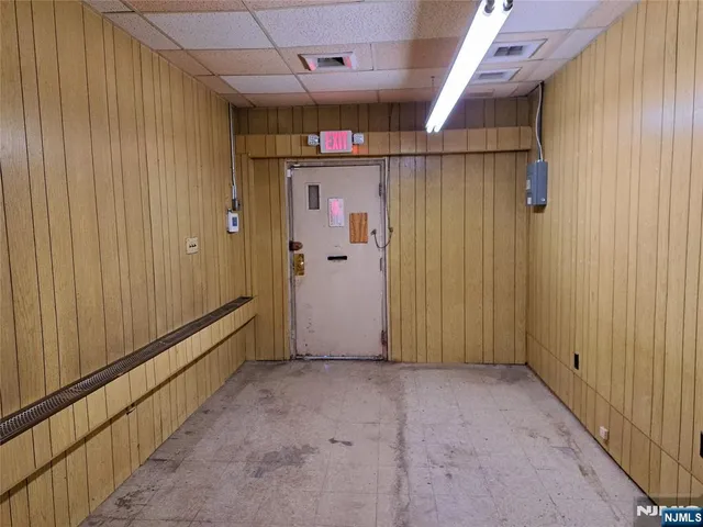 a view of a hallway with wooden shelves