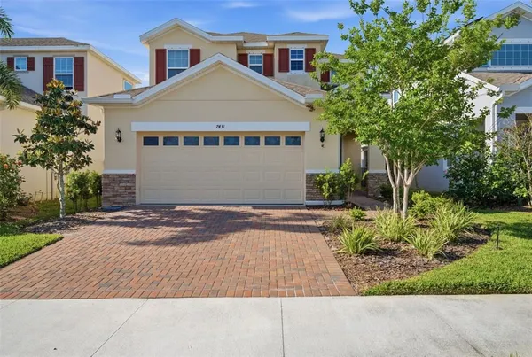 a front view of a house with a yard and a garage