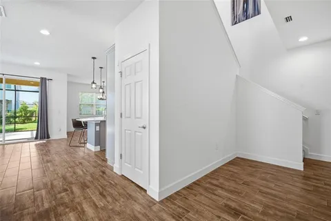 a view of kitchen with granite countertop cabinets and wooden floor