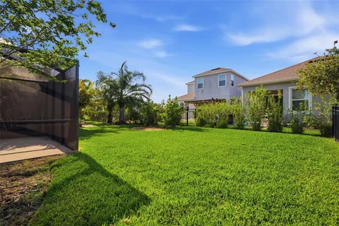 an aerial view of a house with a garden and lake view
