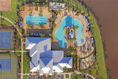 an aerial view of a swimming pool with a yard