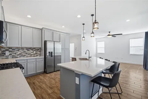 a kitchen with cabinets appliances a sink and a counter top space