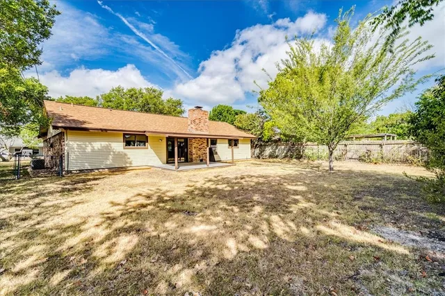 a view of a yard with large trees