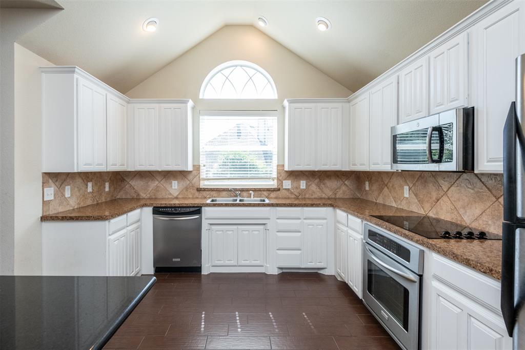 10913 Golfview Way Benbrook, TX 76126 - Photo 11 of 19 a kitchen with stainless steel appliances granite countertop a stove a sink and a microwave