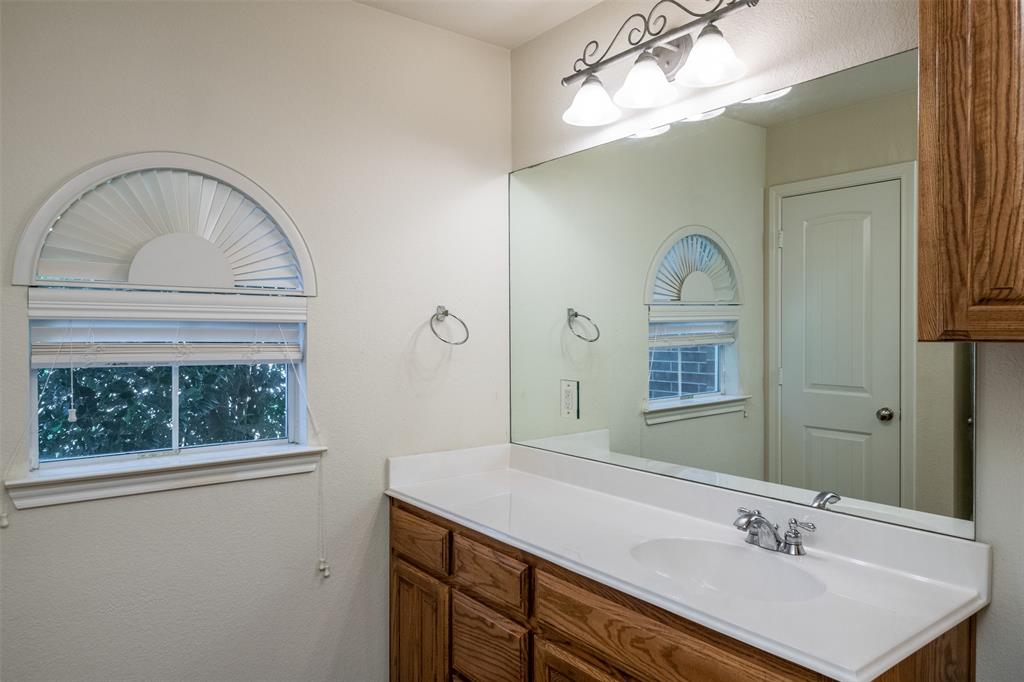 10913 Golfview Way Benbrook, TX 76126 - Photo 14 of 19 a bathroom with a sink a vanity and a mirror