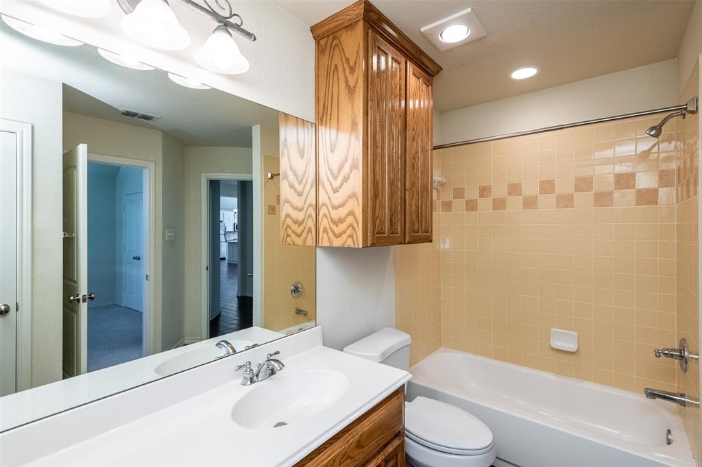 10913 Golfview Way Benbrook, TX 76126 - Photo 15 of 19 a bathroom with a sink a toilet and shower