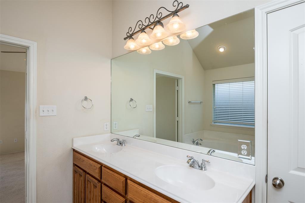 10913 Golfview Way Benbrook, TX 76126 - Photo 3 of 19 a bathroom with a sink and a mirror